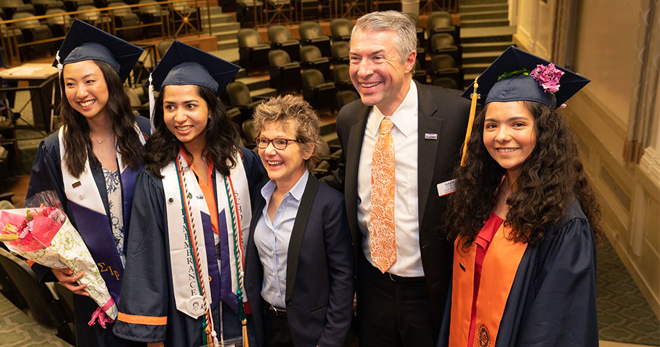 Maxwell School Dean David Van Slyke with students in Maxwell Auditorium.