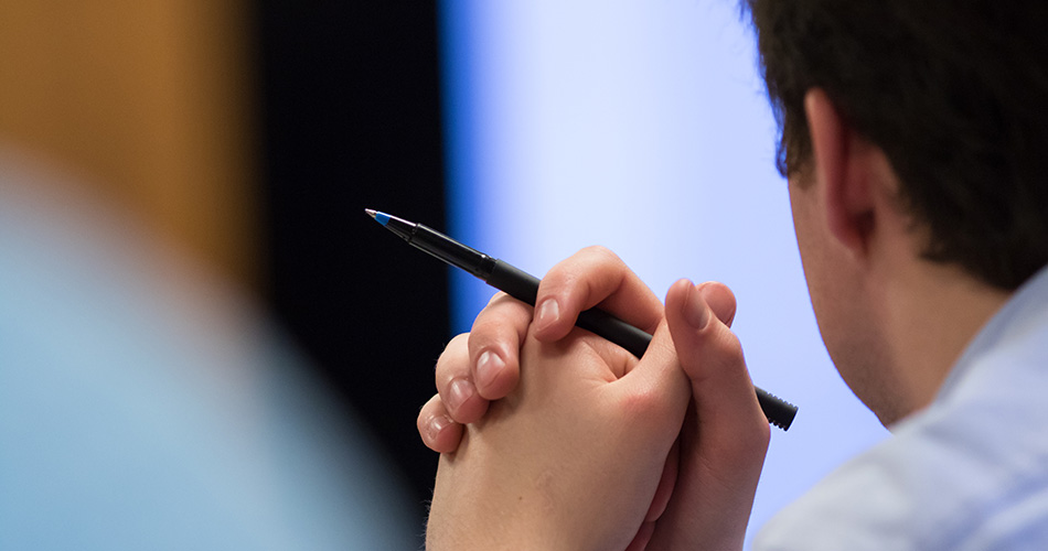 Students hands holding pen