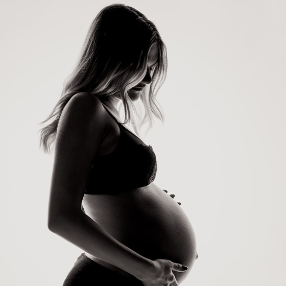 Pregnant woman holding belly