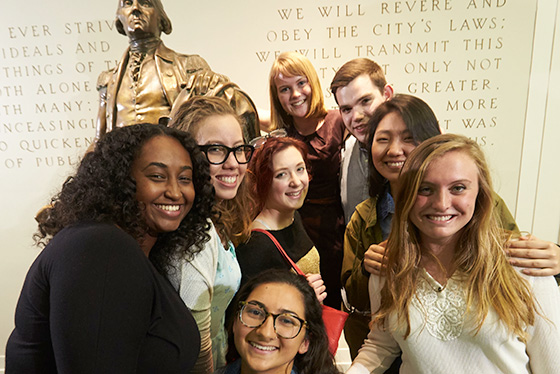 Students standing in front of the George Washington statue in Maxwell Hall