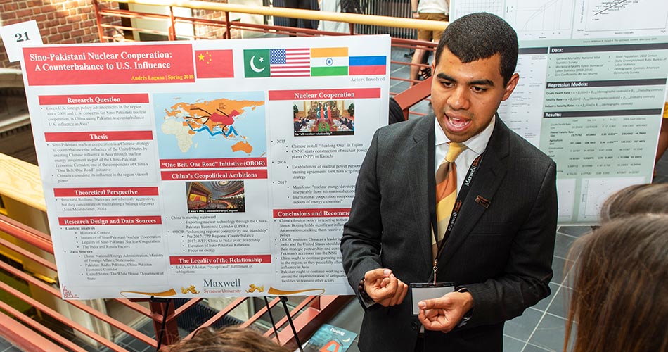 Student giving a poster presentation in Maxwell's Commons area