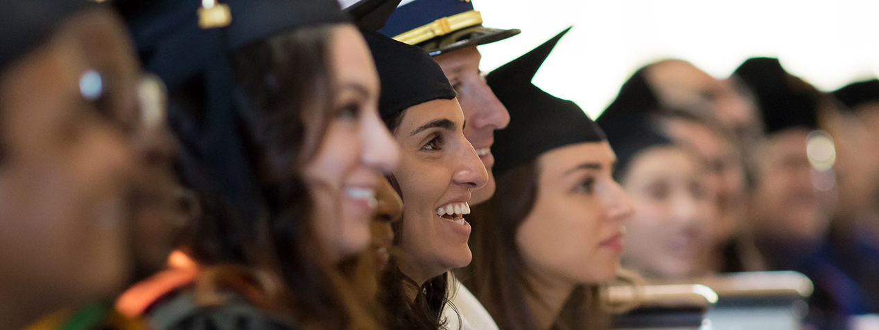 Students in regalia sitting at convocation