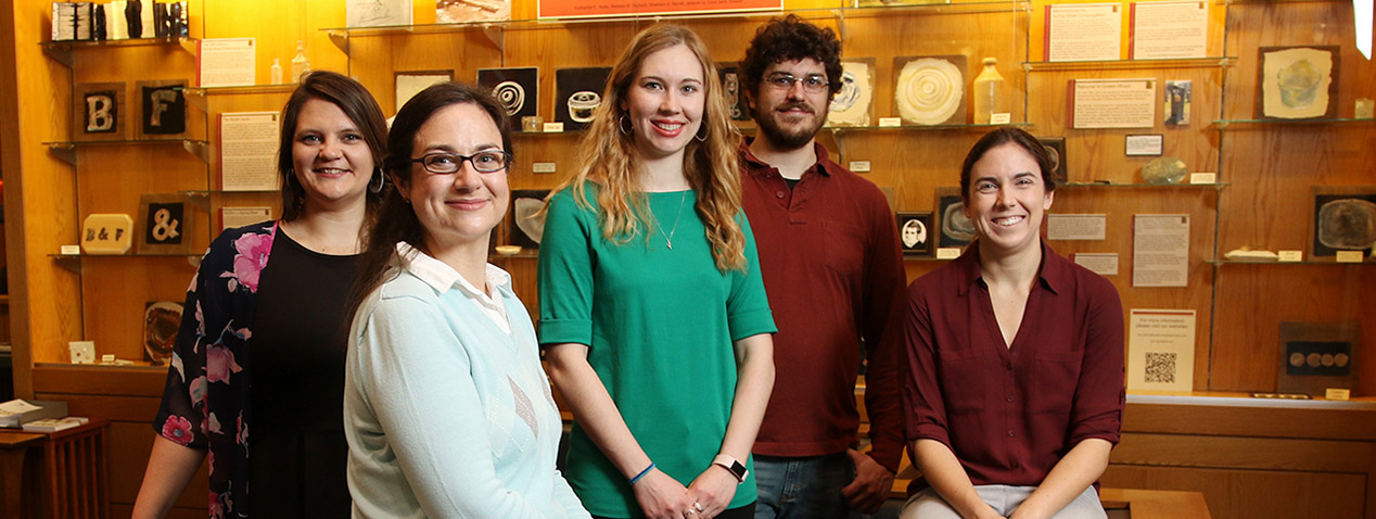 Anthropology students in front of article display case