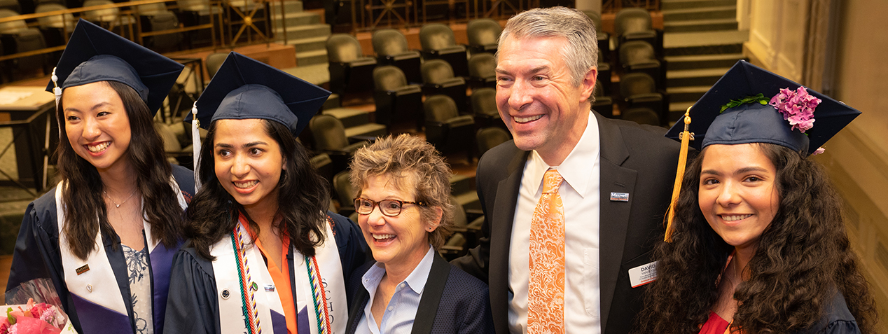 Students in regalia with Dean Van Slyke