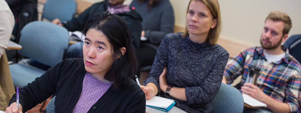 Students taking notes in a classroom