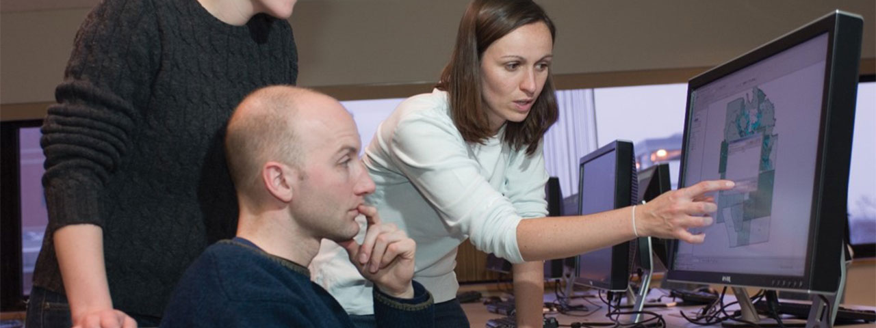 Professor Robinson assists students in Geographic Information Systems lab