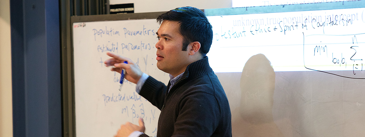 Perry Singleton teaching in front of a whiteboard