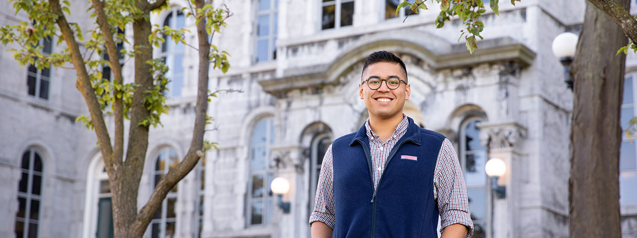 Student in front of building on campus