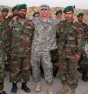 Alumnus Benjamin Tupper in military attire standing with group