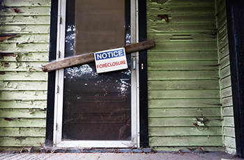 House with foreclosure sign