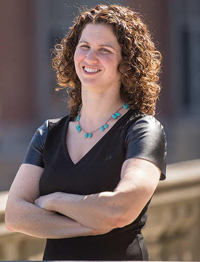 Shana Gadarian posing outside Maxwell Hall on a sunny day