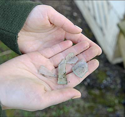 Hands holding a piece of glass