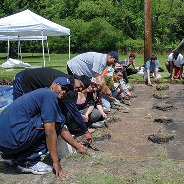 Photo of John Wallace and Billy Owens over an excavation site