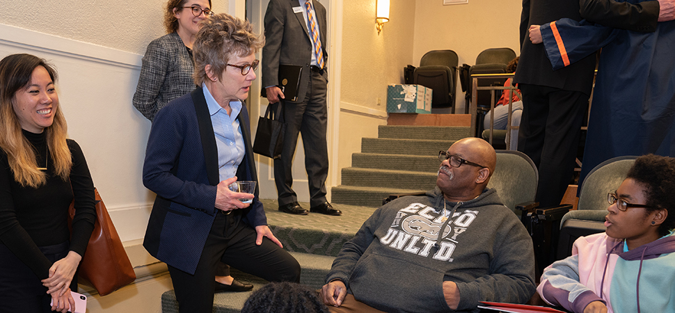 Mary Daly speaking with a student and her family