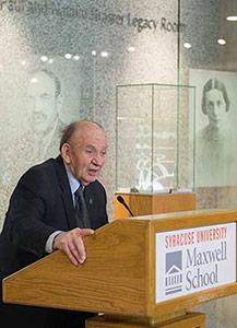 Joseph Strasser addressing an audience from behind a podium