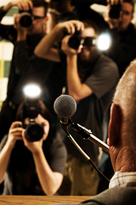 Stock photo of media photgrapher behind a lens