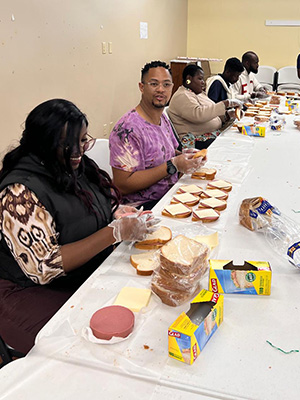 YALI fellows at All Saints Church making sandwiches.