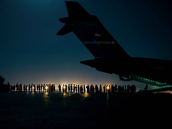 Evacuation in afghanistan. People getting into plane