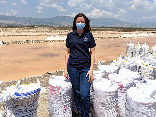 Woman standing with bags surrounding her