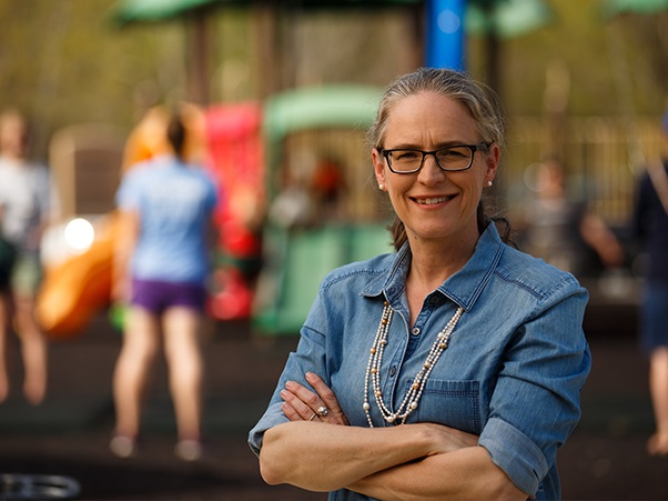 Carolyn Bourdeaux posing in front of blurred background